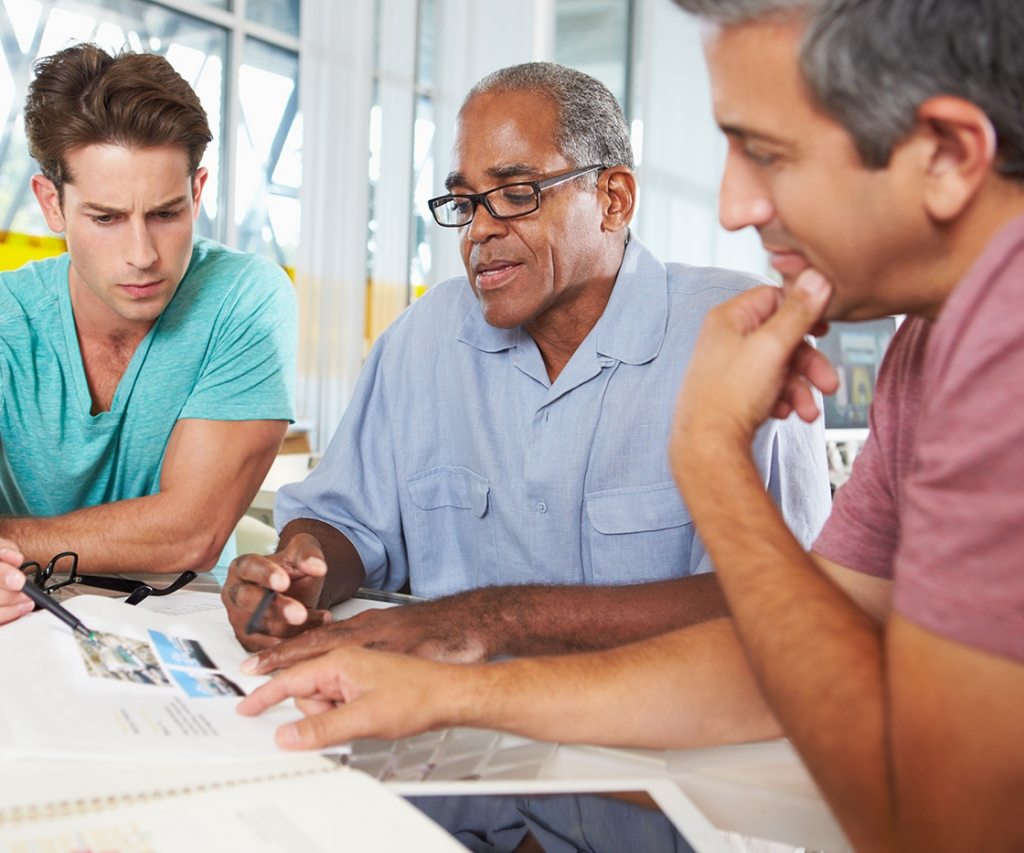 group-of-men-meeting-in-creative-office-PXEKFW4-1024x853